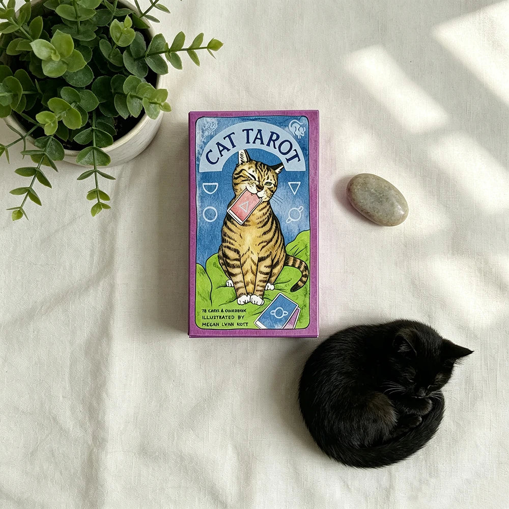 A purple Cat Tarot card featuring a cat illustration and tarot symbols resting on a white cloth.