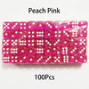 A pack of 100 peach pink acrylic six-sided dice with white dots.