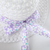 White sunhat and dress set with a lavender floral bow detail