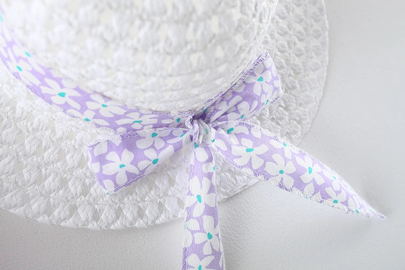 White sunhat and dress set with a lavender floral bow detail