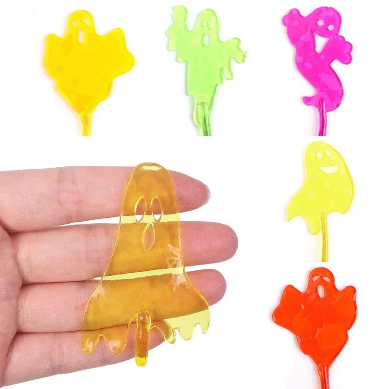 A set of five colorful, translucent, stretchy sticky climbing toys shaped like ghosts and spiders, displayed on a hand.