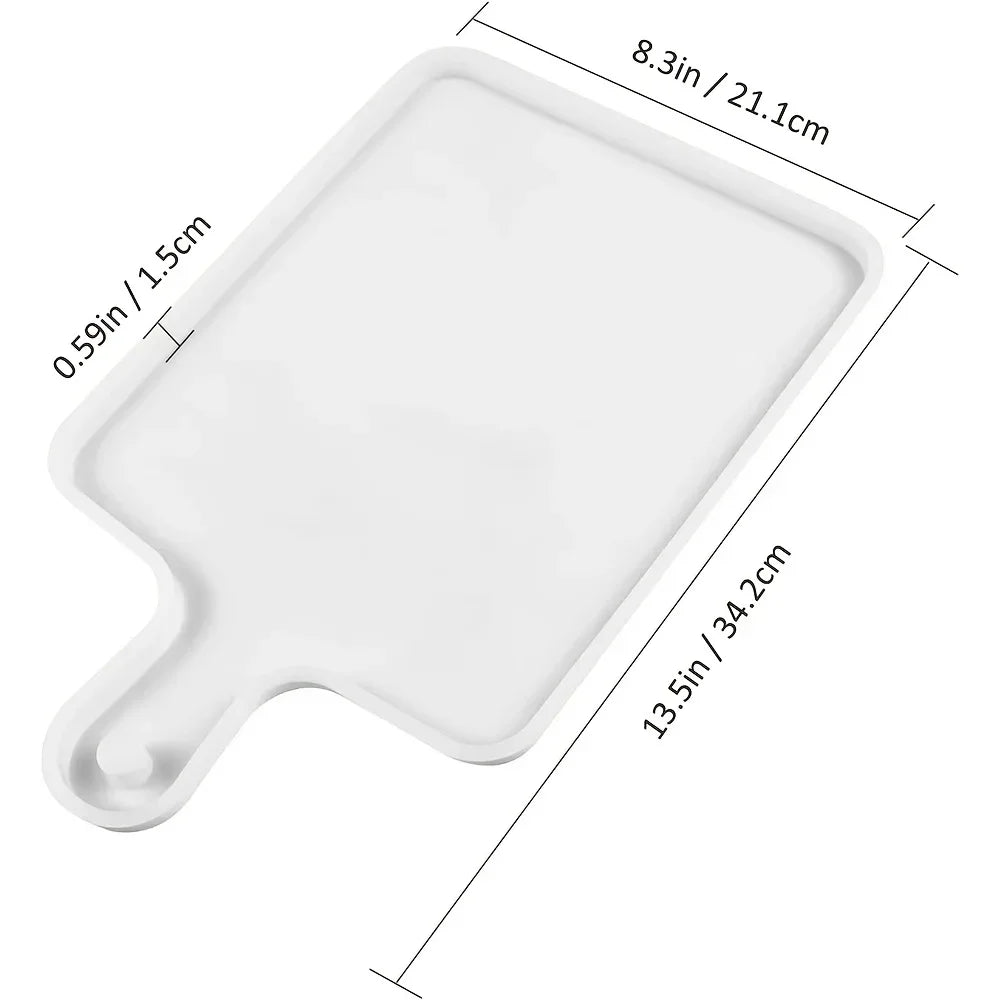 A white flexible silicone resin casting mold with a rectangular base and a curved handle.