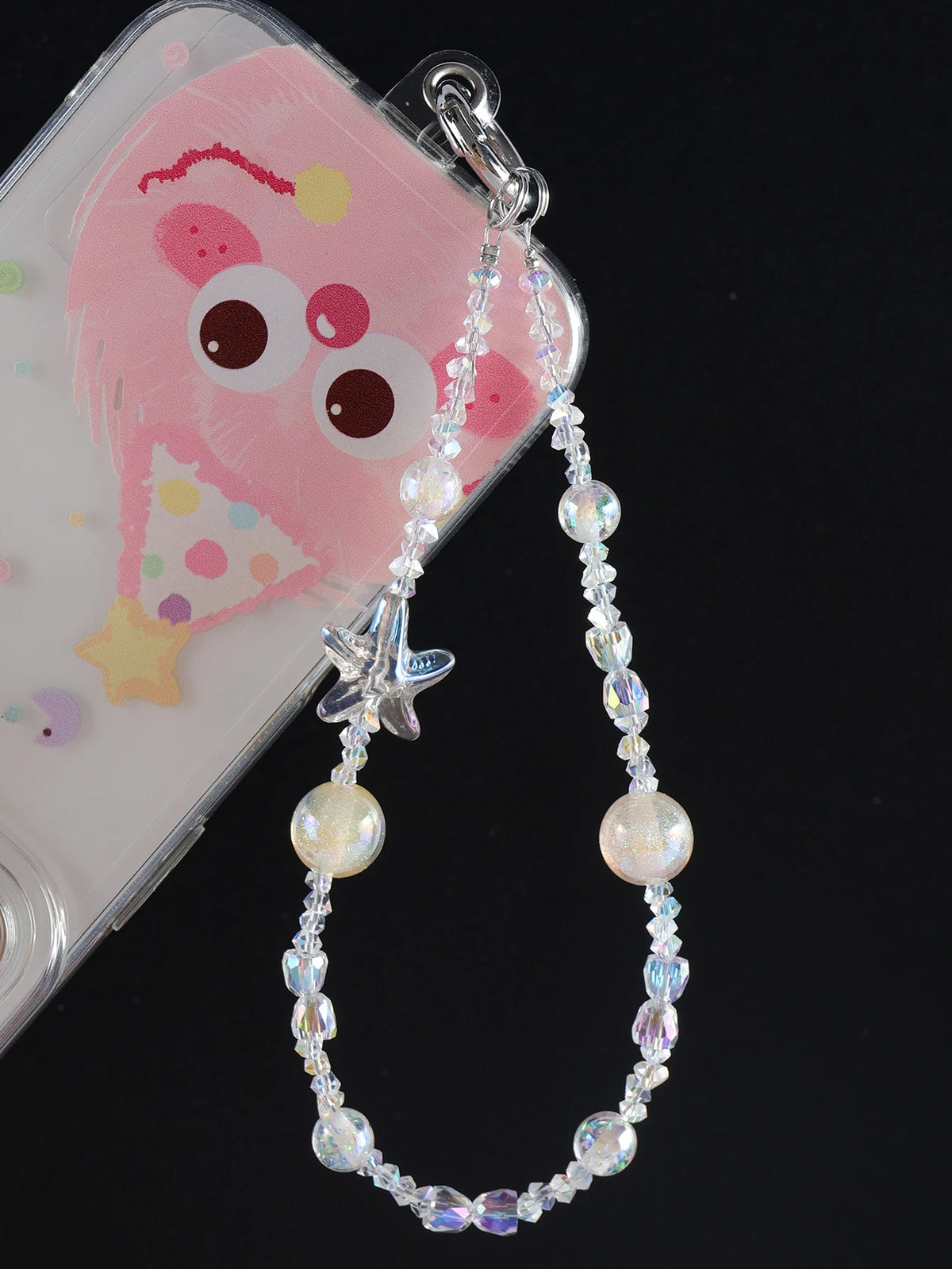A clear plastic bag clip holds a pearl crystal star phone charm with a dangling chain.