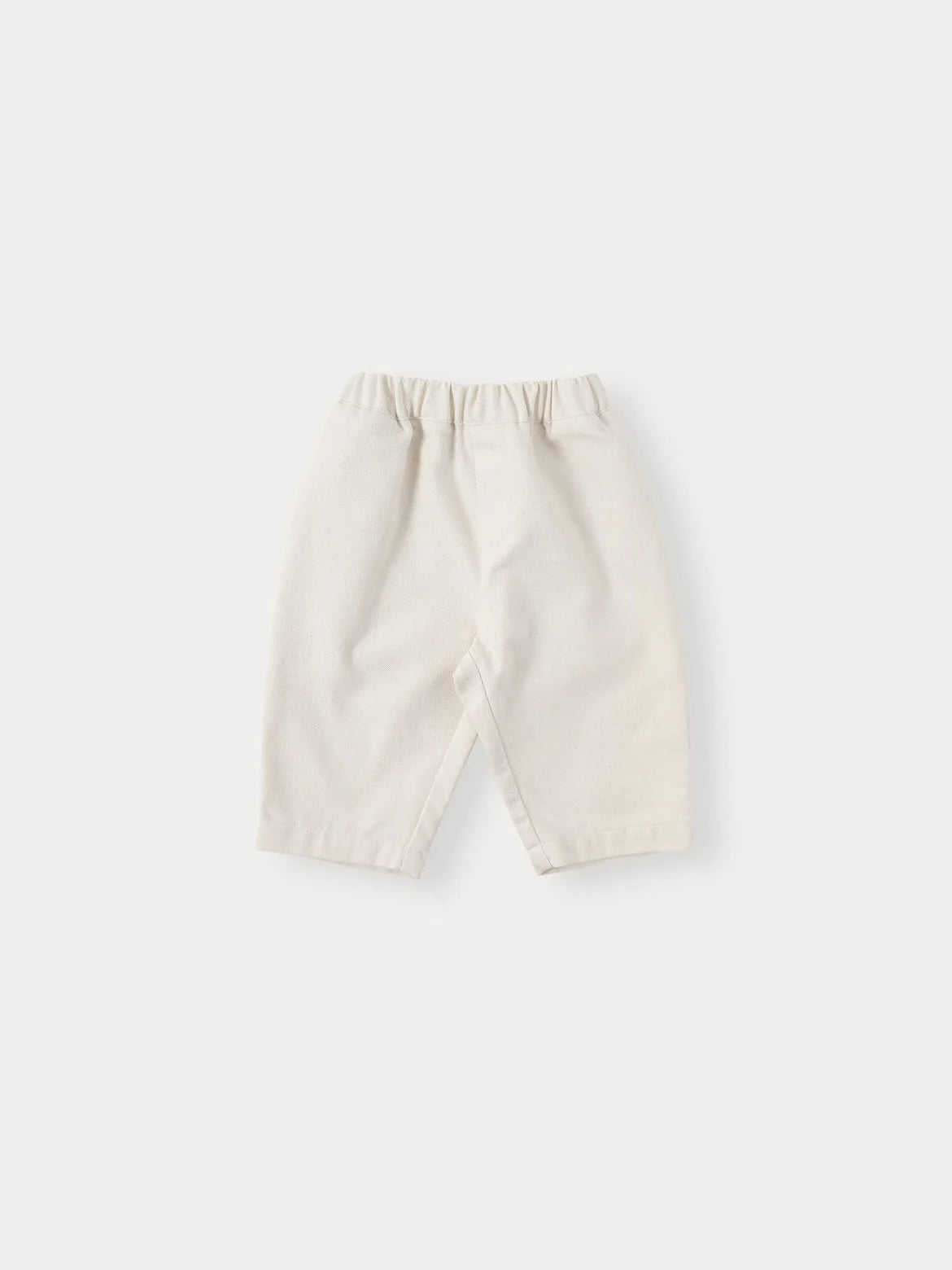 A pair of cream-colored knit sweater and pants set for a toddler.