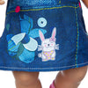 A blue denim skirt featuring a cat print design with pink accents and a small button detail.
