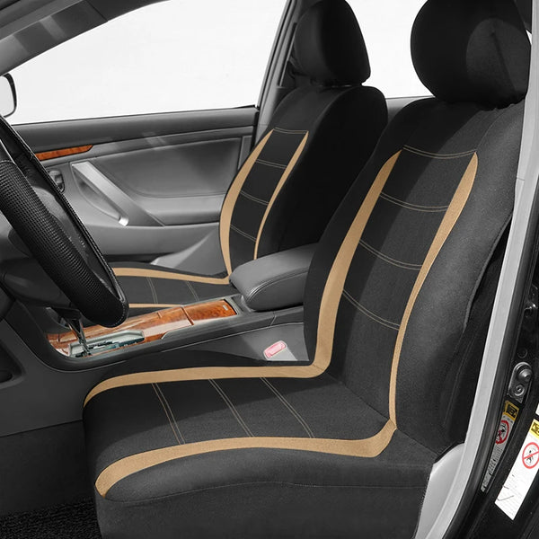 Interior view of a car seat with black fabric covers featuring tan stitching and accents.