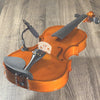 An orange acoustic guitar with a clip-on condenser microphone attached via a gooseneck mount.