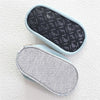 A pair of baby barefoot water shoes is shown, one black and one gray, resting on a white surface.