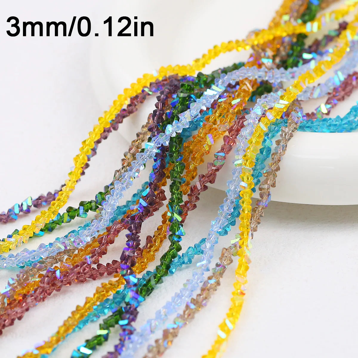 A collection of 3mm crystal triangle beads in various colors like yellow, green, purple, and blue are displayed on a white su