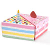 Pink and multicolored paper gift boxes shaped like dots and a candle for party favors