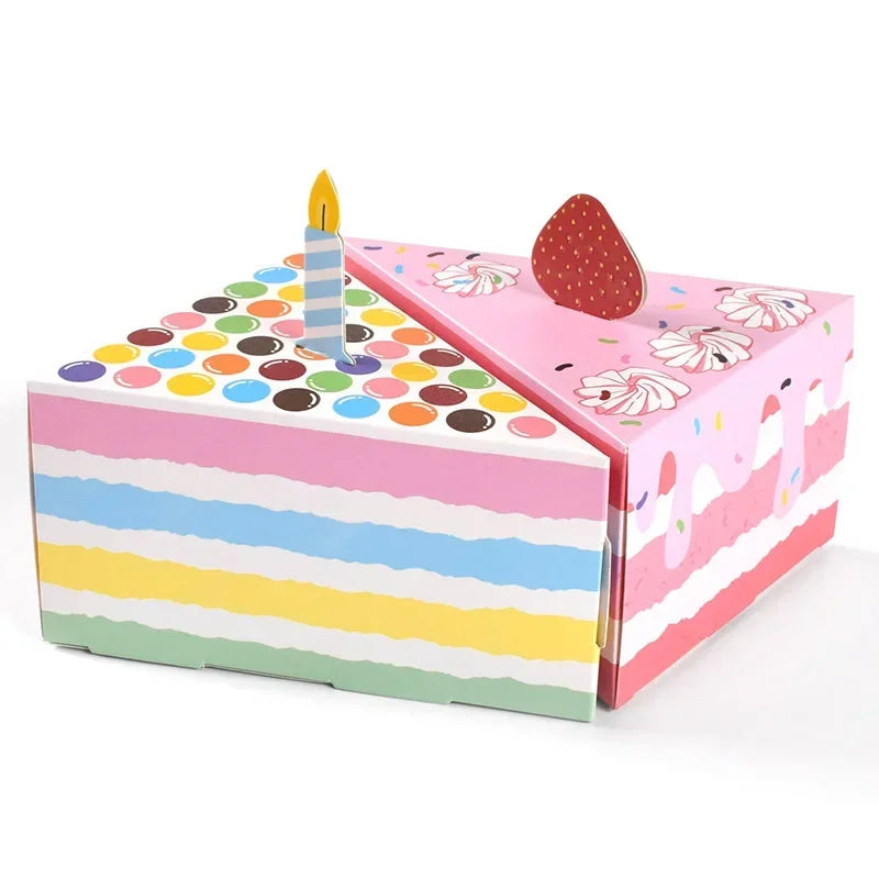 Pink and multicolored paper gift boxes shaped like dots and a candle for party favors