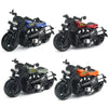 Three vintage-style pull-back motorcycle toys in black, blue, and red colors.