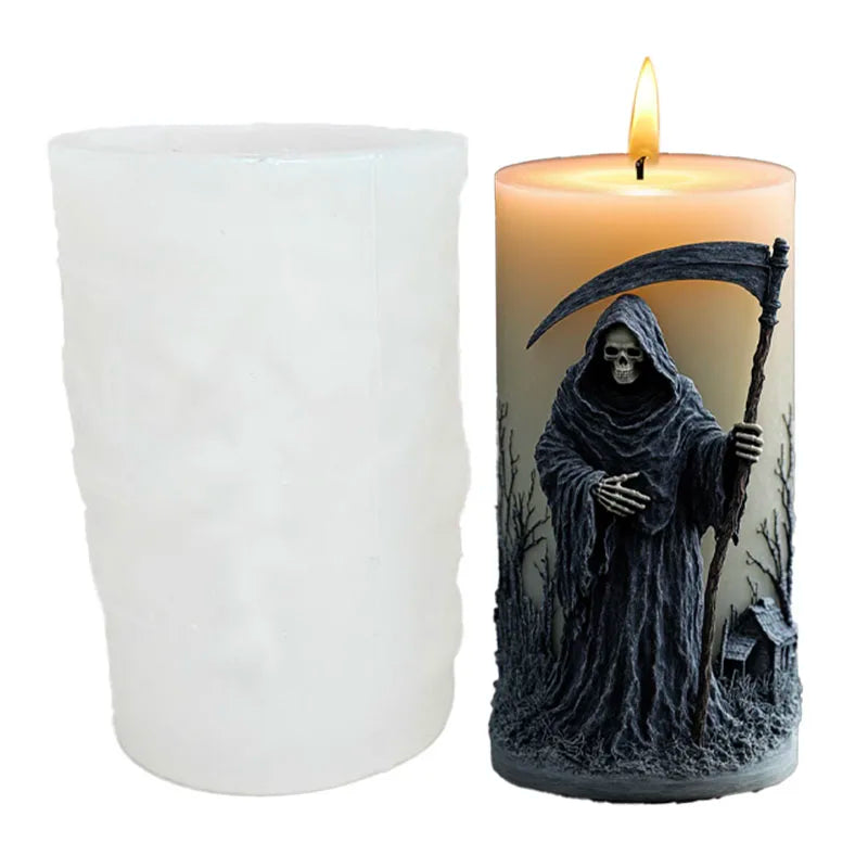 A dark silicone candle mold shaped like a hooded skull with a bat design, featuring a flickering flame.