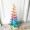 A wooden rainbow ball track toy featuring colorful learning blocks arranged in a vertical, tree-like structure.