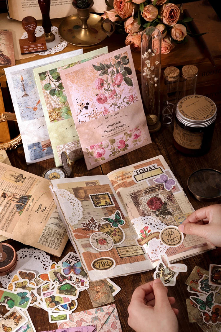 A collection of vintage stickers and patterned paper sheets for crafting laid out on a wooden surface.