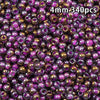 A close-up view of 340 golden gradient glass beads in various shades of purple and gold.