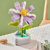 A building block set shaped like a purple and white rose flower with yellow center, displayed on a white surface.