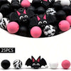 A set of 25 silicone beads shaped like bats and round balls in black, pink, and white for jewelry and crafting.