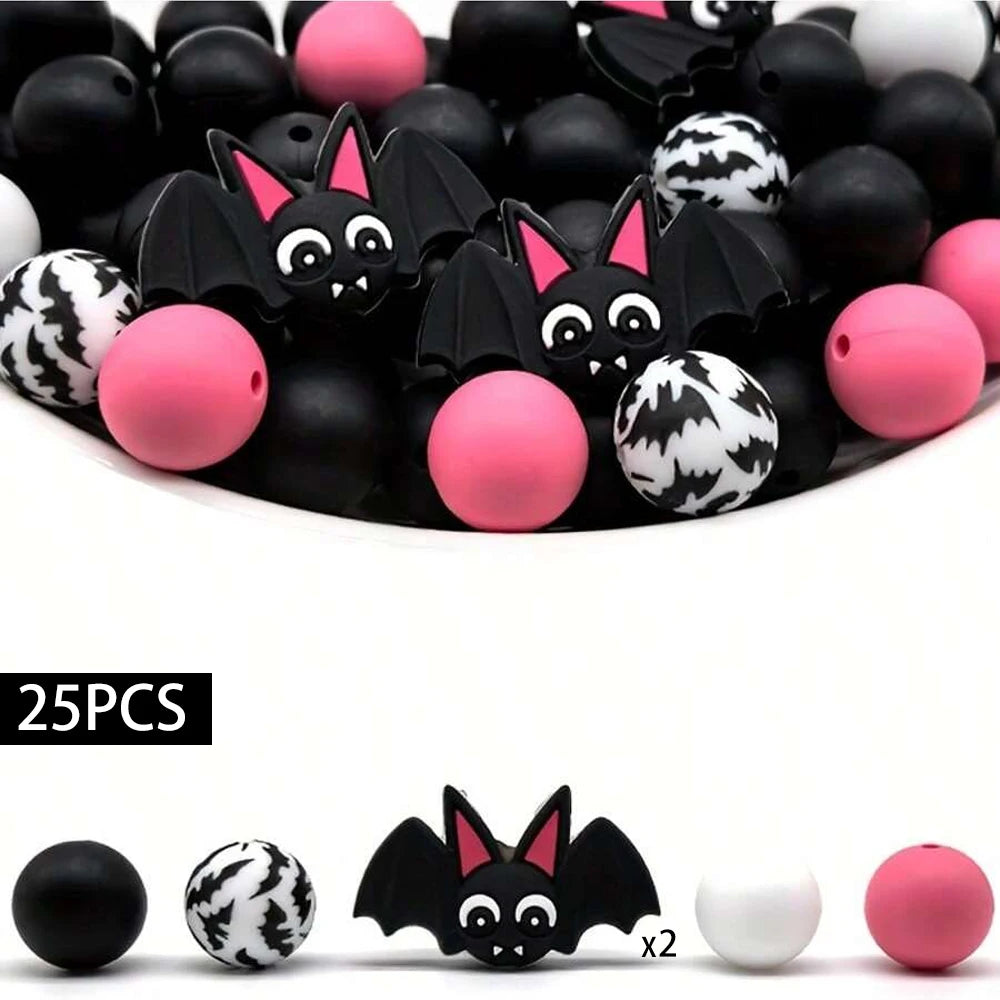 A set of 25 silicone beads shaped like bats and round balls in black, pink, and white for jewelry and crafting.