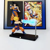 A figurine of Son Goku performing a Kamehameha pose, illuminated by a blue light, displayed on a black base.