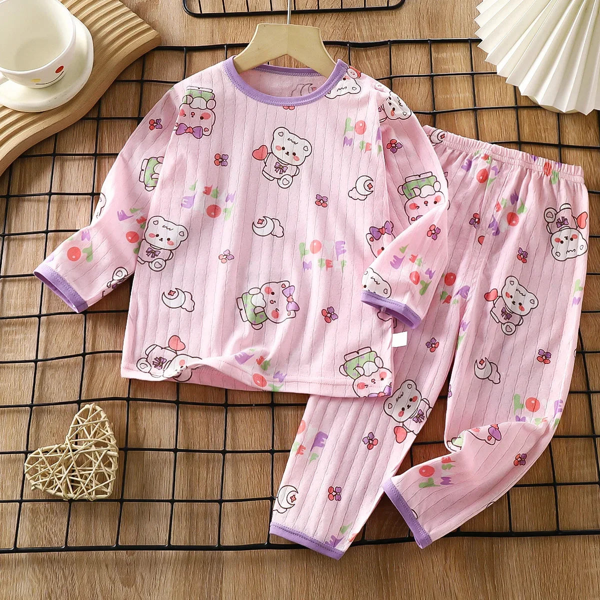 Pink long sleeve cotton pajama set for kids featuring cute bear and animal patterns