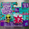 A packaged set of Little Pet Shop figures featuring a lime green animal and a red star shape.