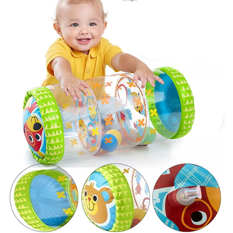 A smiling baby is interacting with a clear plastic crawling roller toy featuring colorful wheels and designs.