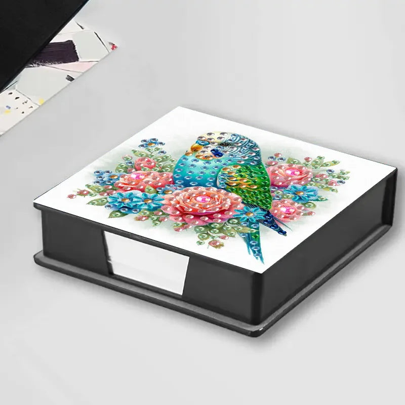 A square storage box for DIY diamond painting featuring a colorful bird pattern with 150 gemstones.