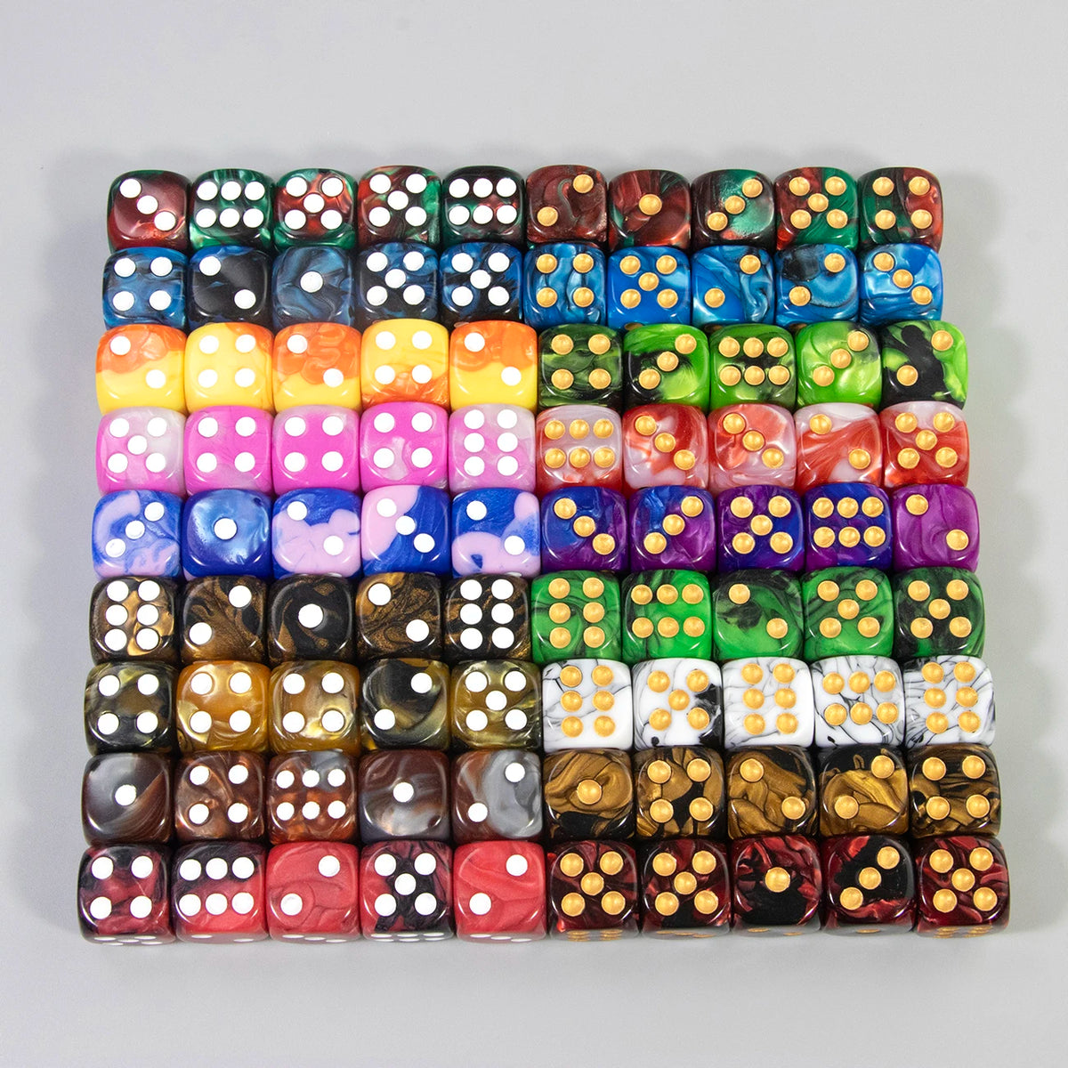 A row of ten 16mm acrylic D6 dice in various colors and patterns arranged in a grid.