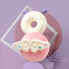 A soft, round white baby head protector pillow with purple straps and a pink cloud-shaped accessory.