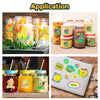 A collection of colorful holographic rainbow sticker paper sheets and various liquid products displayed on a wooden surface.