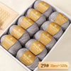 A box of Merino wool yarn balls with yellow labels showing the weight 29# and quantity 10 pieces totaling 500g