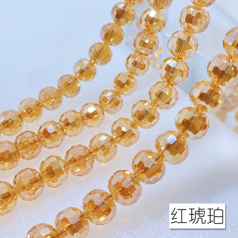 A string of small, round, amber-colored crystal beads with an AB coating.