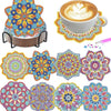 An assortment of colorful diamond painting coasters and a coffee cup with latte art.