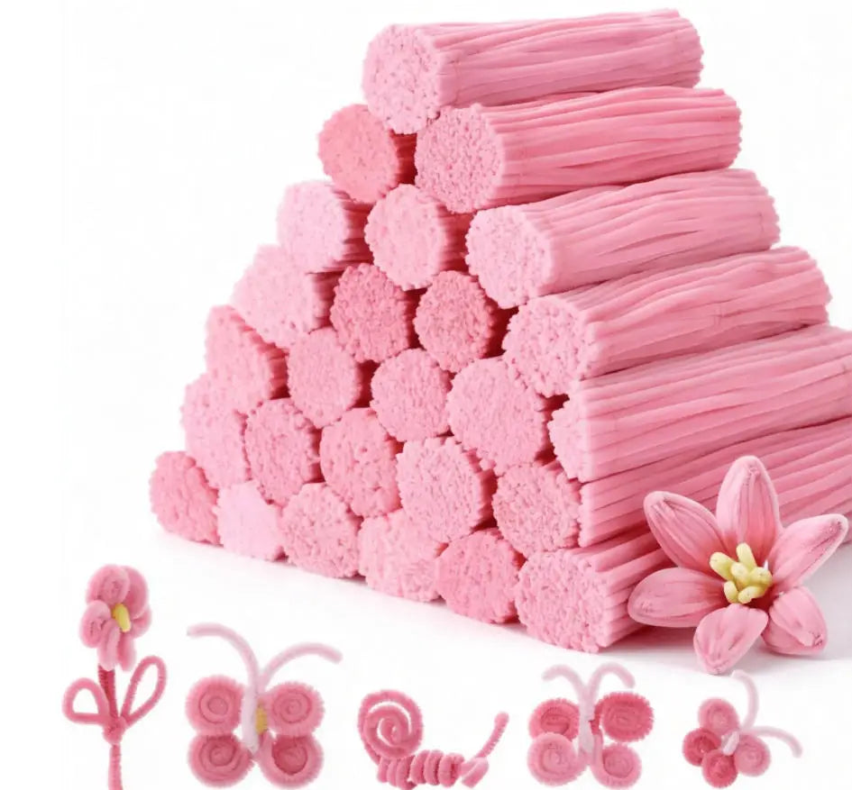 A pile of pink chenille craft pipe cleaners and several small pink flower shapes.
