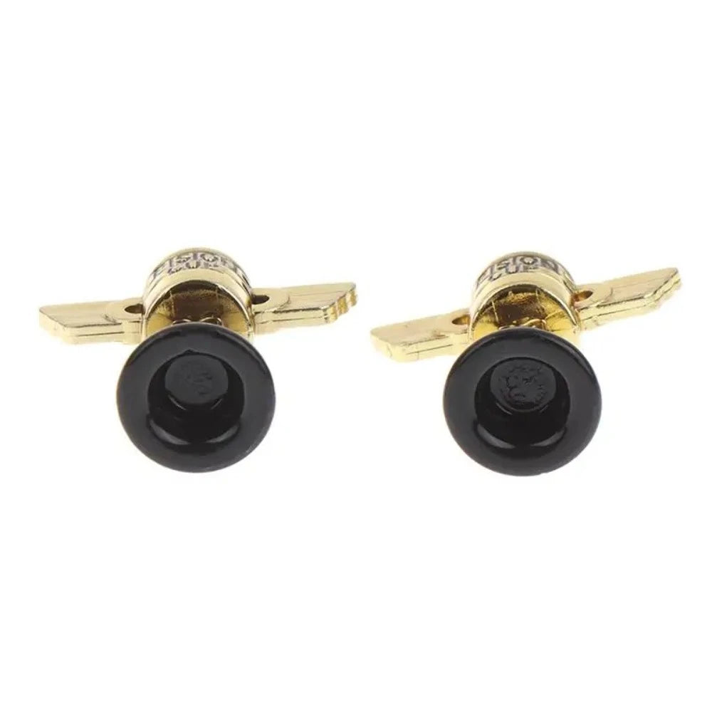 A pair of mini golden trophy cups with black bases for kids and events.
