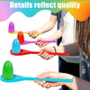 Hands are shown playing an Easter egg and spoon race game with colorful plastic eggs and spoons.