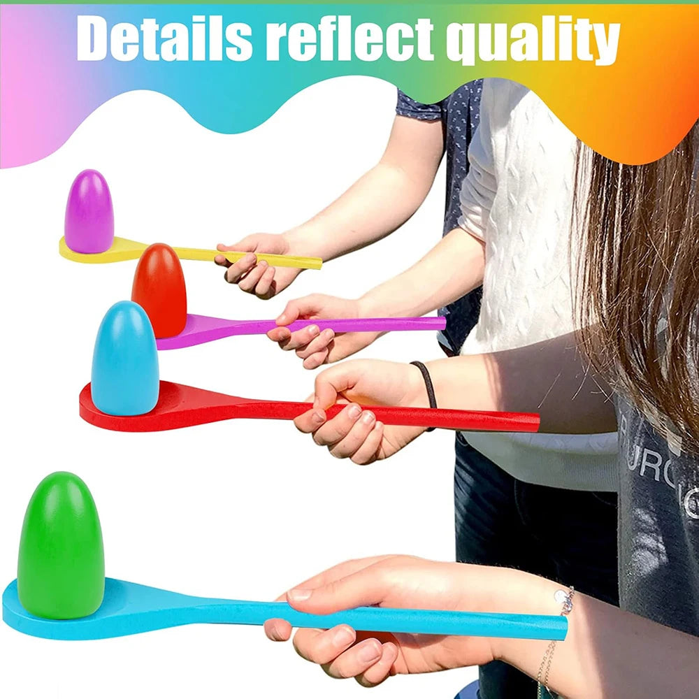 Hands are shown playing an Easter egg and spoon race game with colorful plastic eggs and spoons.