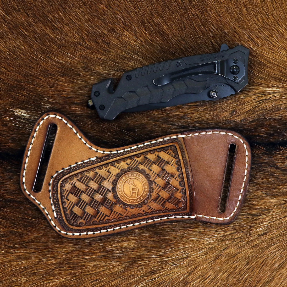 A handcrafted leather knife sheath with a belt loop resting on brown fur.