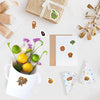 A collection of funny meme cat and food fruit stickers scattered on a white surface with a gift box and a paper card.