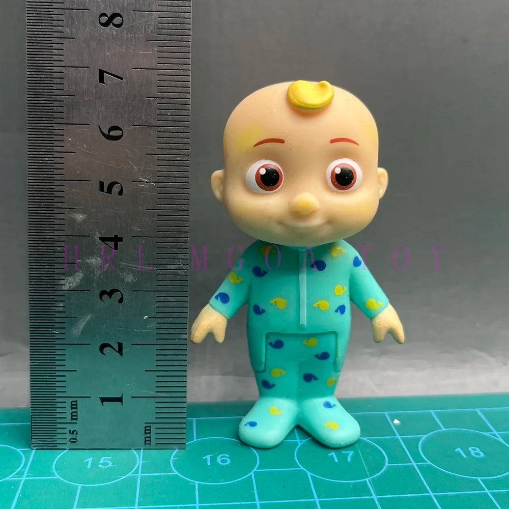 A cute, yellow-skinned cartoon figurine with large eyes wearing a teal school uniform featuring yellow polka dots.