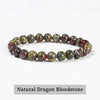 A bracelet made of natural dragon bloodstone beads in various shades of pink and green.