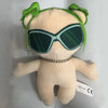 A plush doll featuring green hair, sunglasses, and a gold necklace.