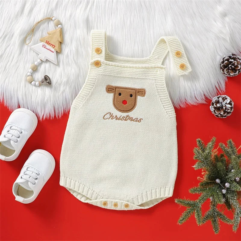 A cream knit baby romper with a brown Santa embroidery and wooden buttons, displayed on a red background with white faux fur.