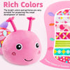 A pink caterpillar plush toy with large eyes and a smiling mouth is shown against a background of colorful patterns.