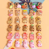 A collection of mini capybara resin figurines in various colors and sizes arranged vertically on a light background.
