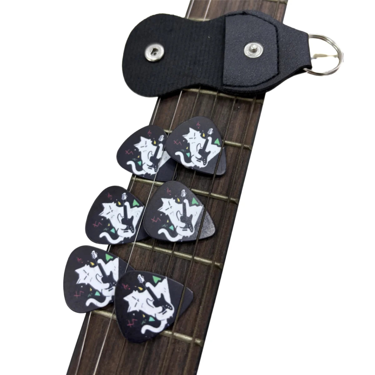 A set of six decorative guitar picks with a white and black cat design mounted on a black leather keychain holster.