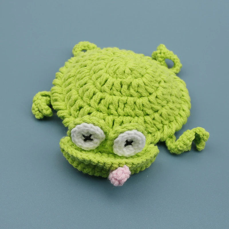 Handmade crochet lizard coaster in bright green with white eyes and pink tongue