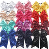 A collection of twelve glitter sequin pigtail bows in various colors and shades for girls