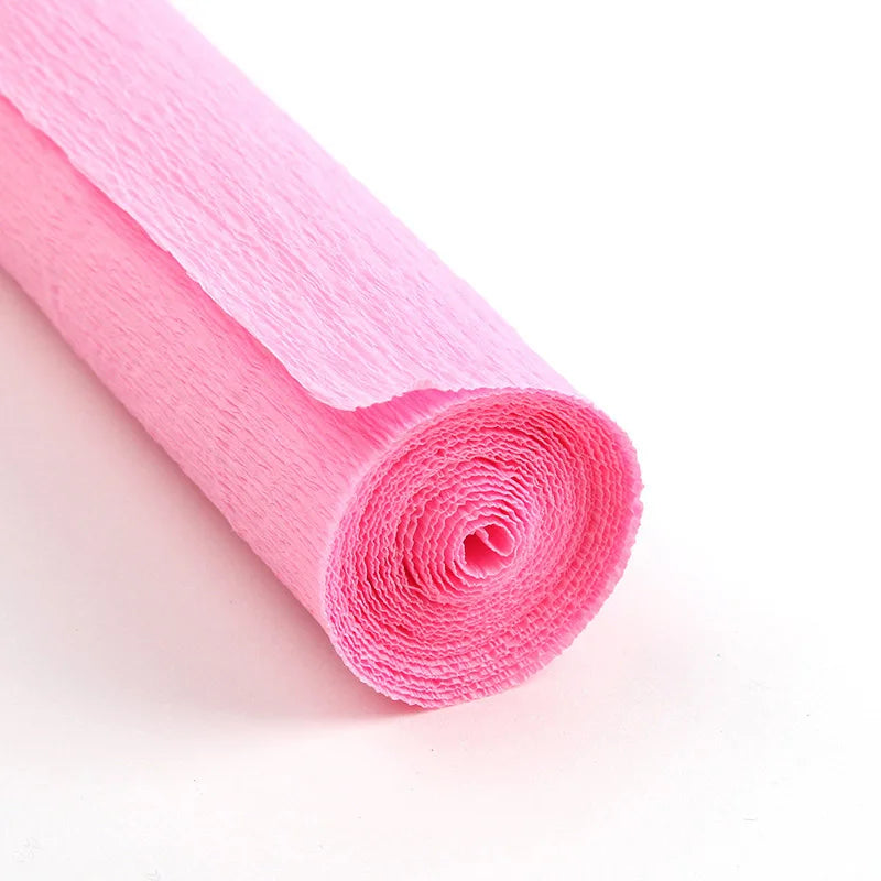 A roll of pink crepe paper for DIY crafts and gift wrapping.
